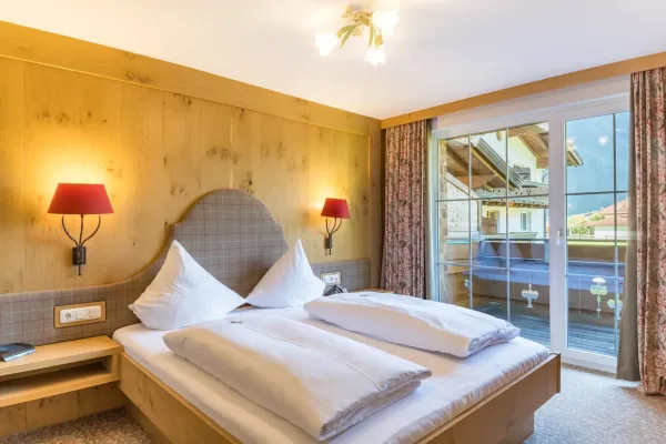 Familien Junior Suite - Blick auf das Bett und ins Freie